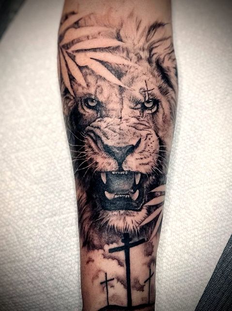 Black and grey realism lion forearm
