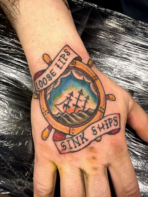 Colour traditional banner hand tattoo