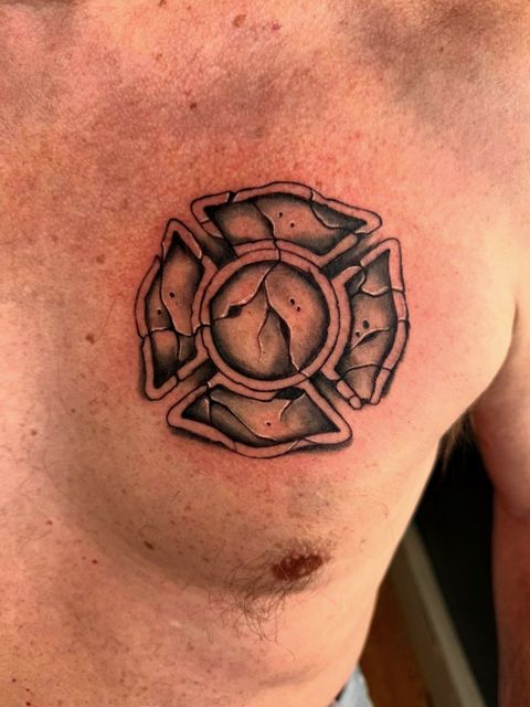 Maltese cross chest tattoo
