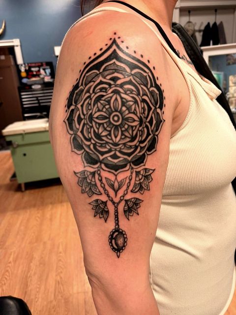 Ornamental mandala shoulder tattoo