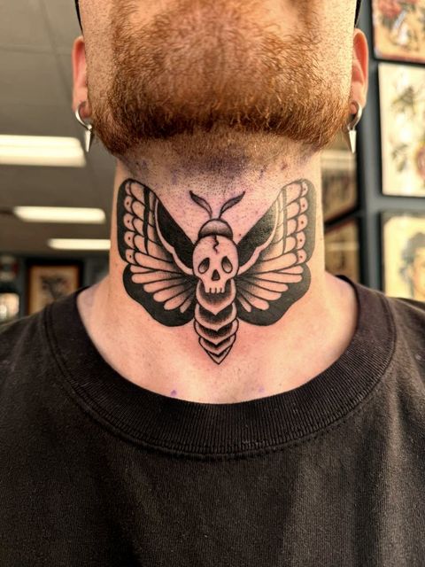 Black and grey moth neck tattoo