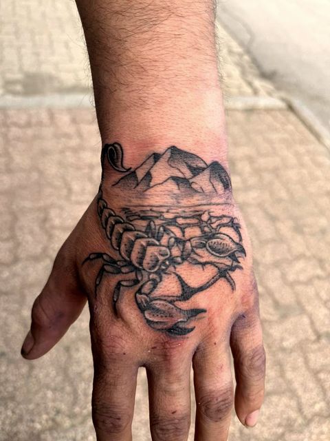 Blackwork scorpion hand tattoo