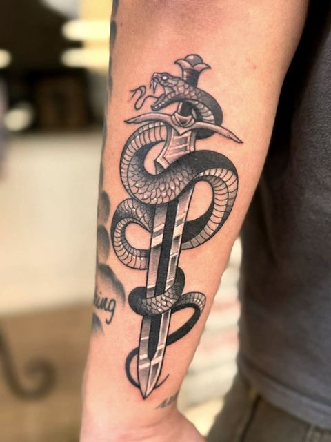 Snake and dagger arm tattoo